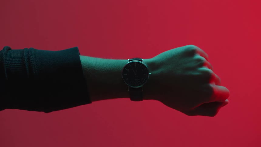 Arm with a long black sleeve and a wristwatch