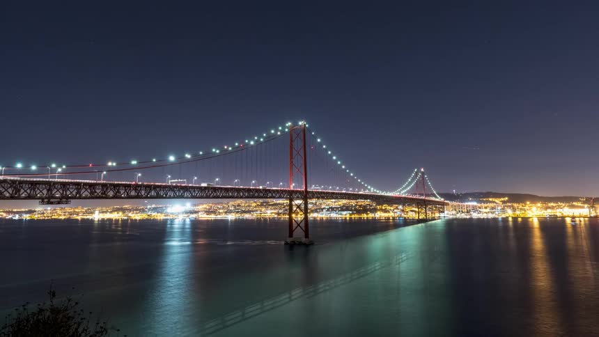 Time lapse view of cars passing over a bridge is displayed at night