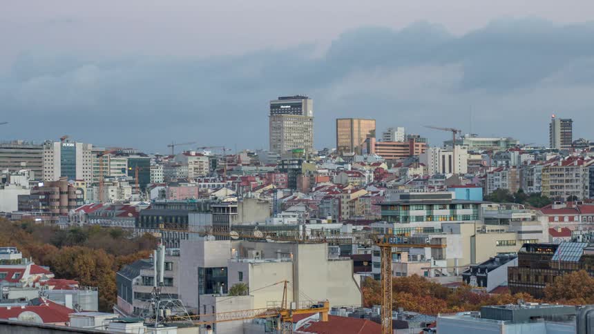 Clouds move over a city and neighborhoods as the sun rises
