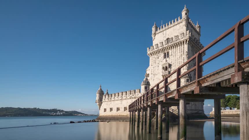 Time lapse of a castle tower on the coast of a bay at daytime