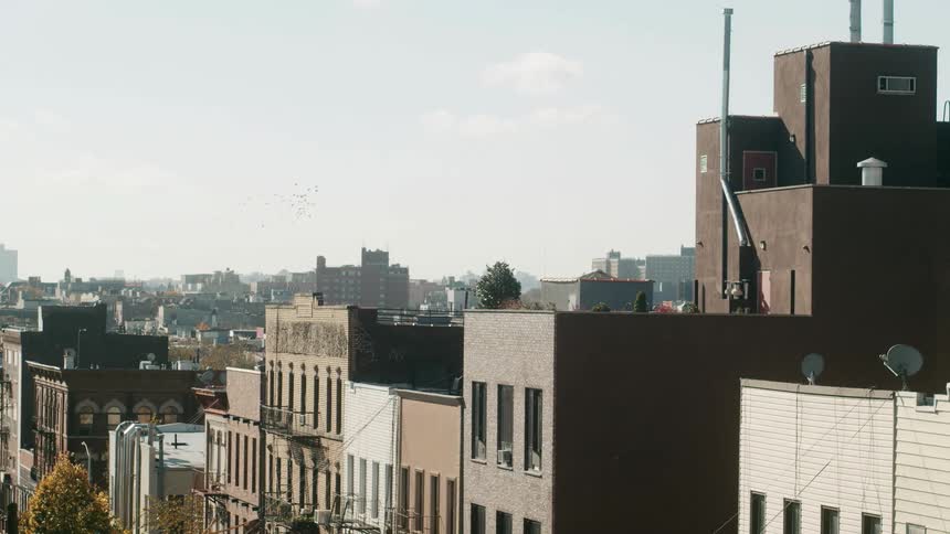 Aerial view of a city with tall buildings is displayed