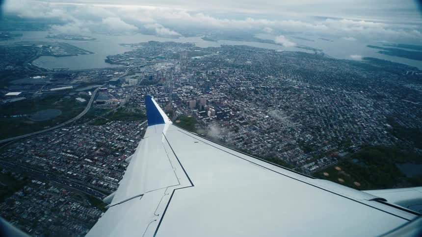 Aerial view of an airplane is flying in the sky
