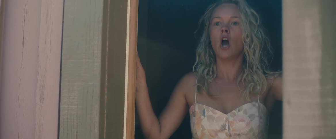 Blonde woman banging on window indoors yelling no and stop