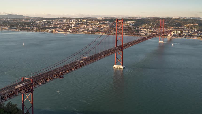 Aerial view of cars driving over a bridge is displayed