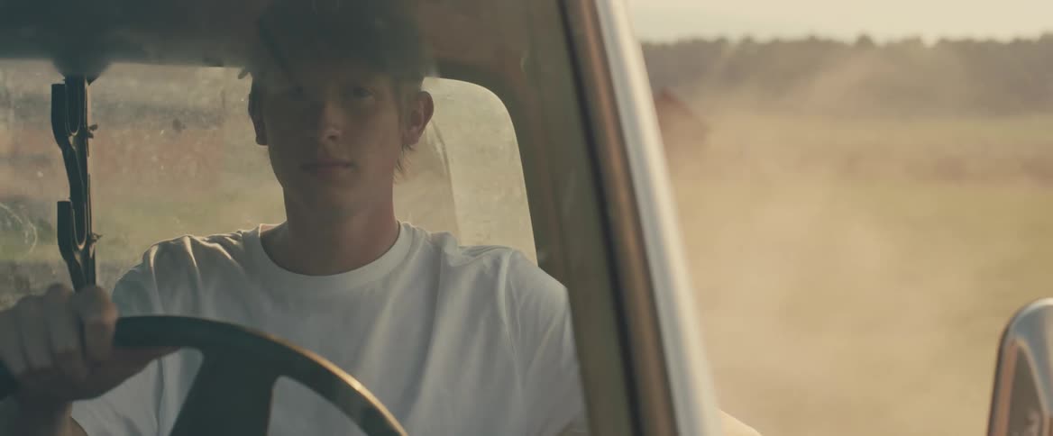 White man driving his car at a rural area