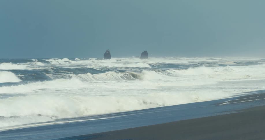 Foamy ocean waves break against the shore