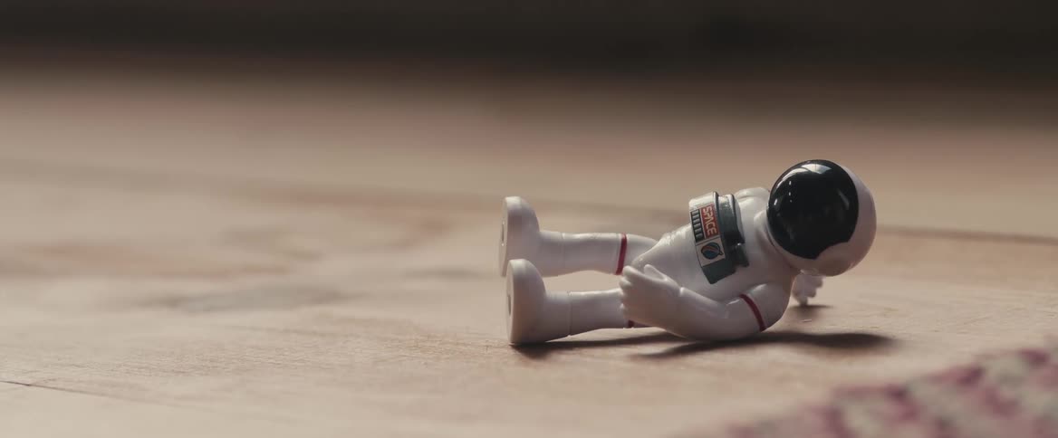 A toy space man is on the floor