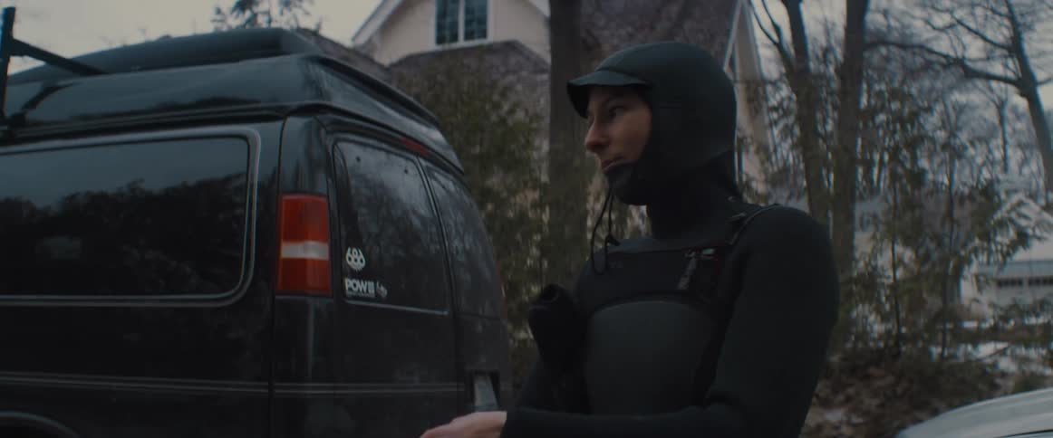 A view of a person putting on a wetsuit