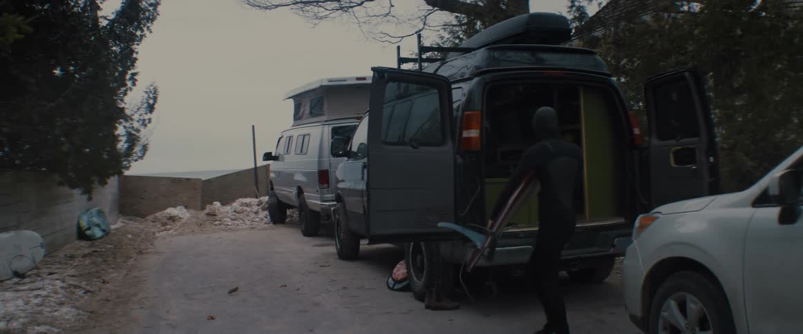 A person is taking items out of a car in spring