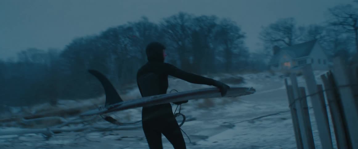 A person is walking to his house from the beach