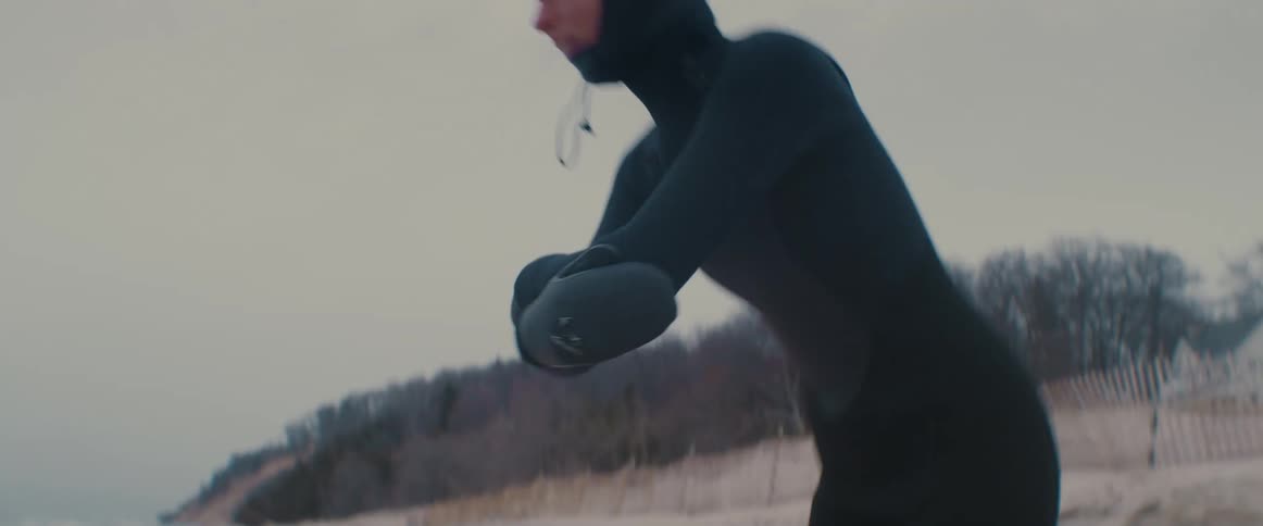 A person is on the coast of a beach and stretching