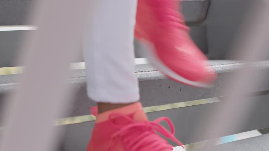 Close up of feet going down wooden steps
