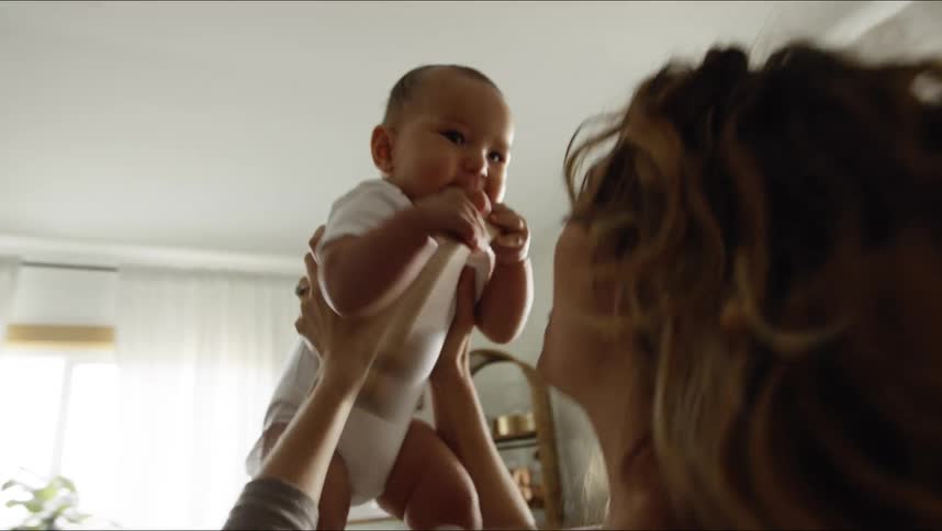 A mother and daughter dancing in a room