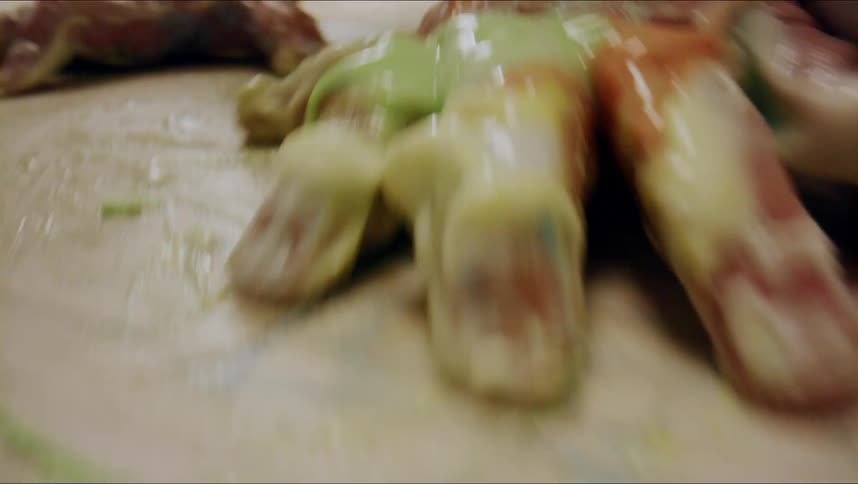 Closeup of baby painting with colored frosting on the floor