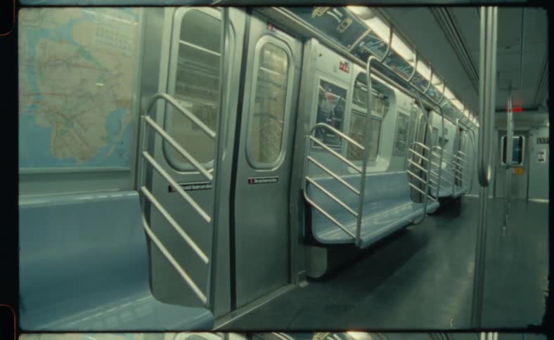 Train doors open and close on an empty car