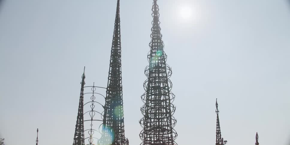 Tall art iron structures tower into the sky by the street