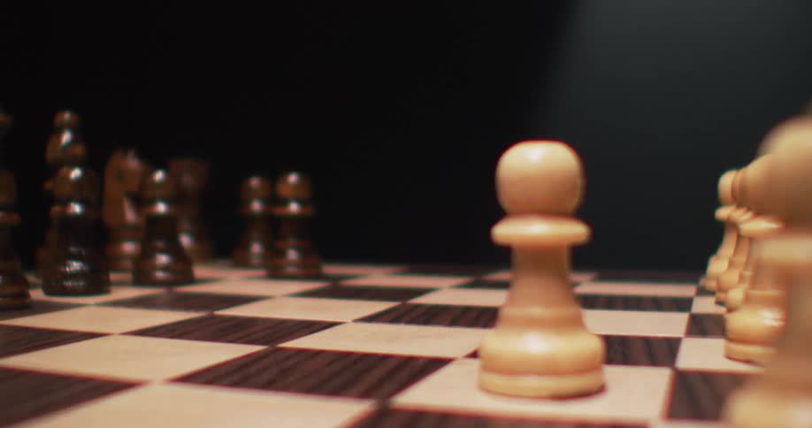 A view of chess pieces moving on a board