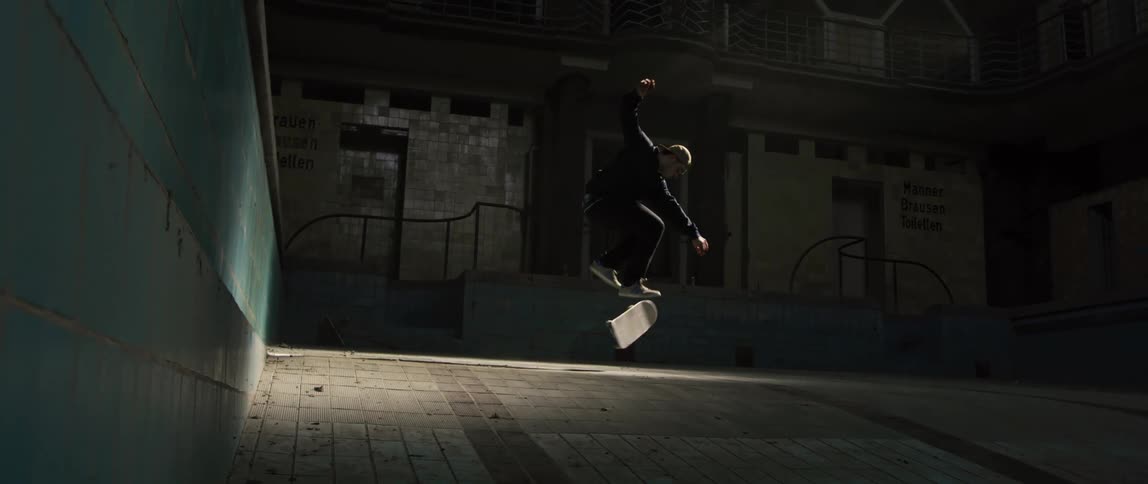 A man does a jump on his skateboard