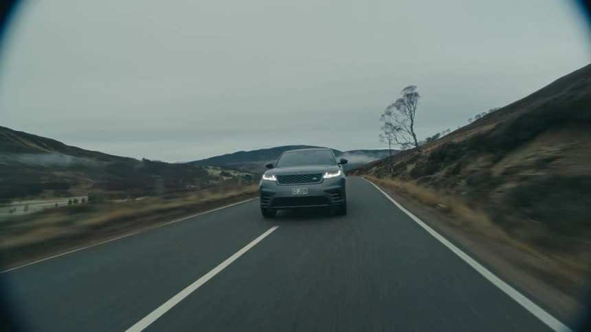 Gray car drives on highway in countryside