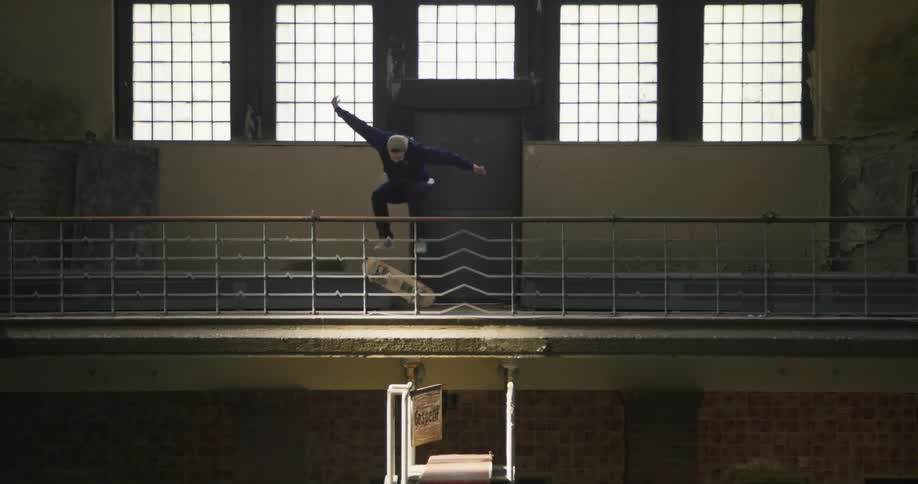 A man jumps on his skateboard in the building