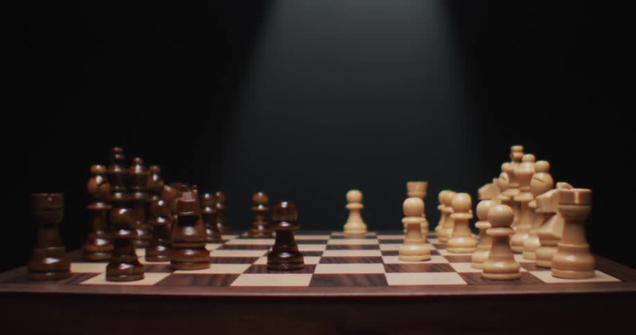 The chess pieces slowly slide on the board