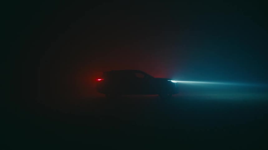 Headlights and tail lights illuminate on a vehicle at night