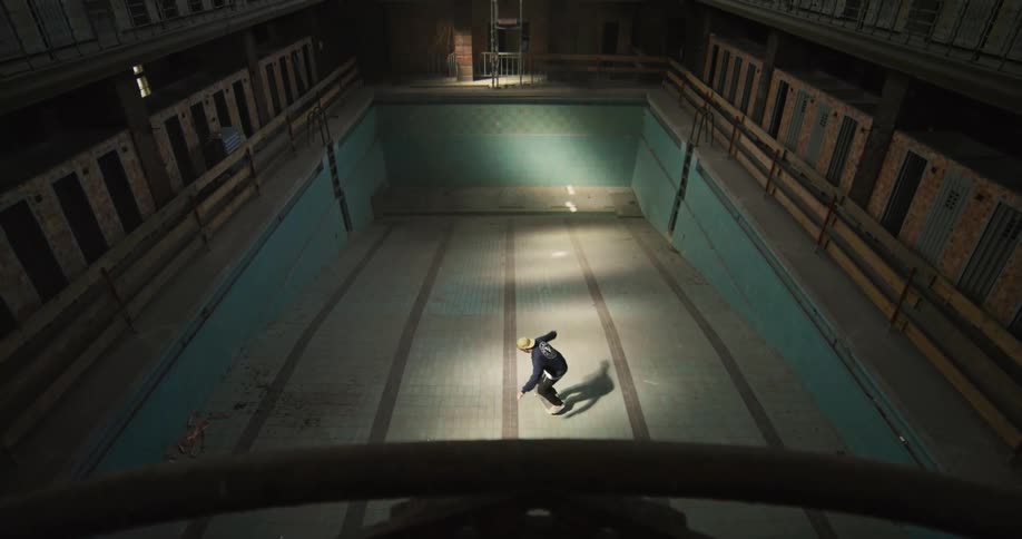 A view of a person skateboarding indoors