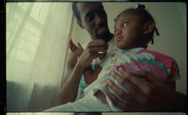 Father is holding his daughter indoors