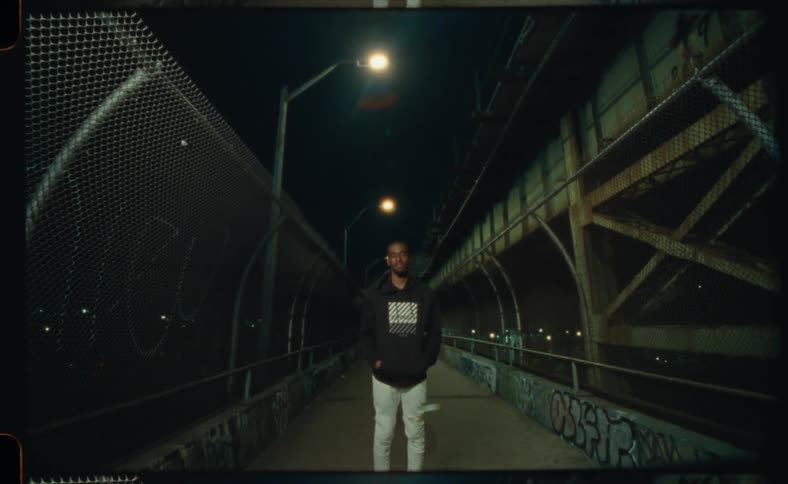 A man is standing outdoors at night