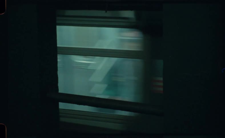 A subway train speeds up as it leaves the station
