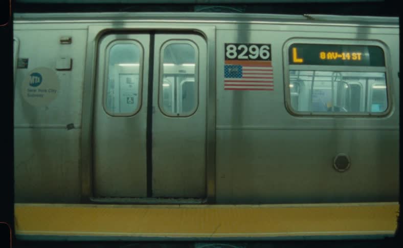 A subway train is stopped and the doors close and it moves away