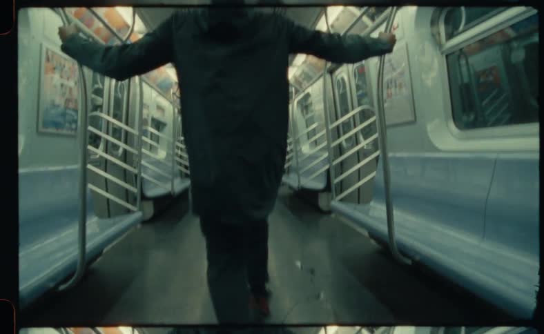 Black man dances inside an empty subway car