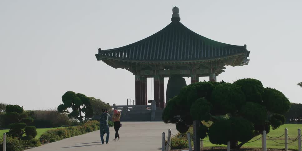 People are walking around a park in the spring time