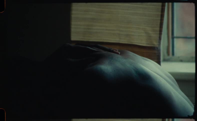 Man bends near window as his back is massaged