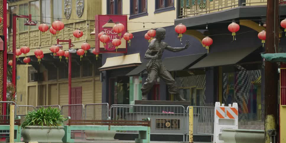 A statue of a martial artist is near the building