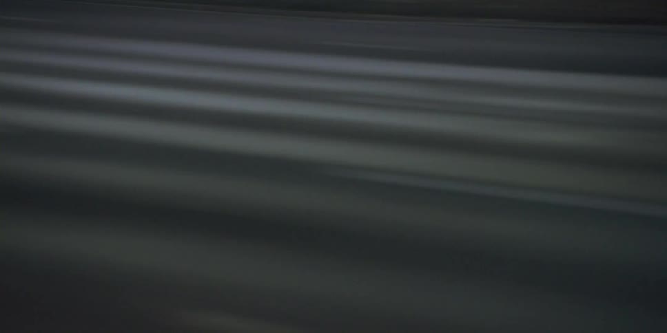 Cars are driving on a highway during the daytime