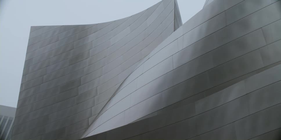 Grey modern building full of curves and no windows