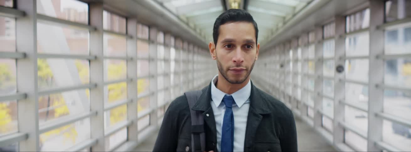 A man is walking downtown in an overpass
