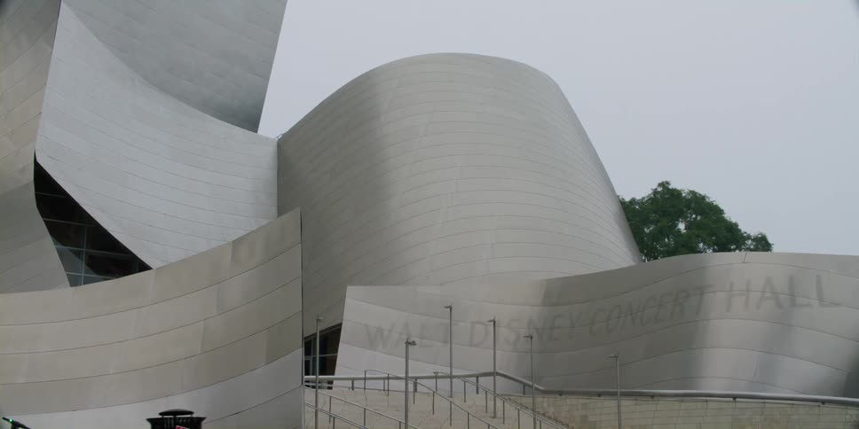 A concert hall exterior with a modern design on an overcast evening