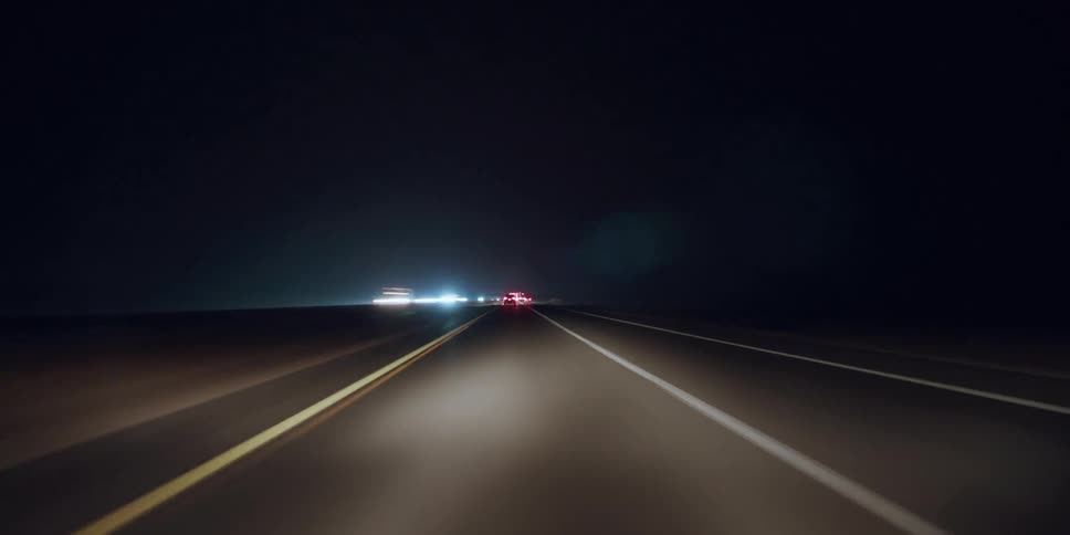 Time lapse view from dash cam driving on freeway at night
