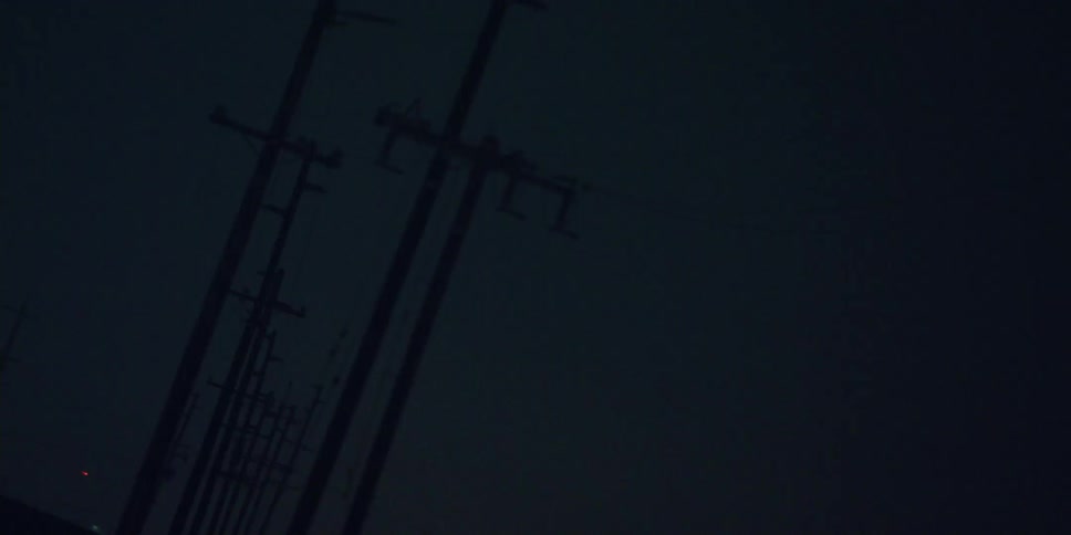 Utility poles are high in a night sky