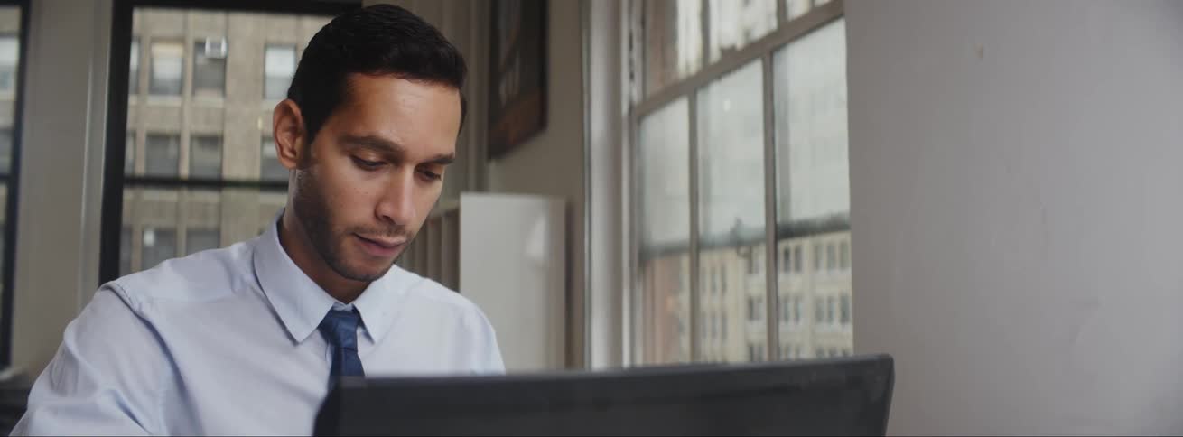 Man working on laptop in an office building