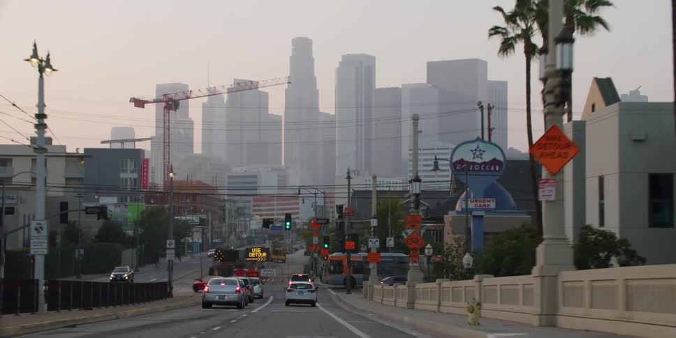 Cars are driving towards a downtown city