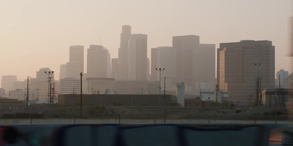 The city is covered in fog at sunrise