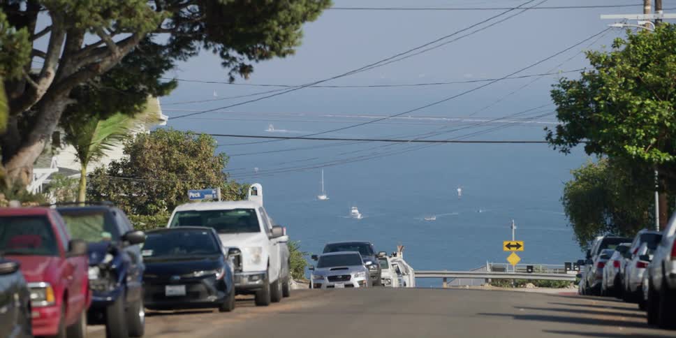 Vehicles and boats travel by the town
