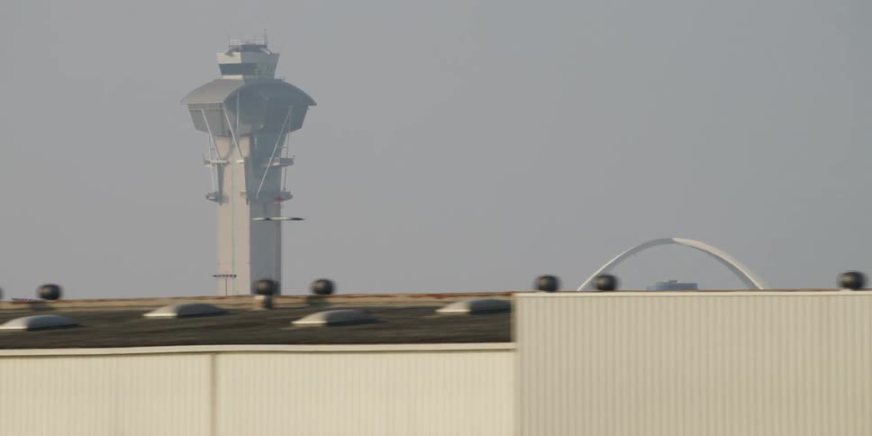 A tower looms over a shipping warehouse near downtown