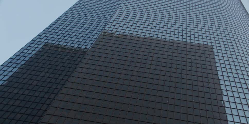Aerial view of a skyscraper is displayed in an urban city