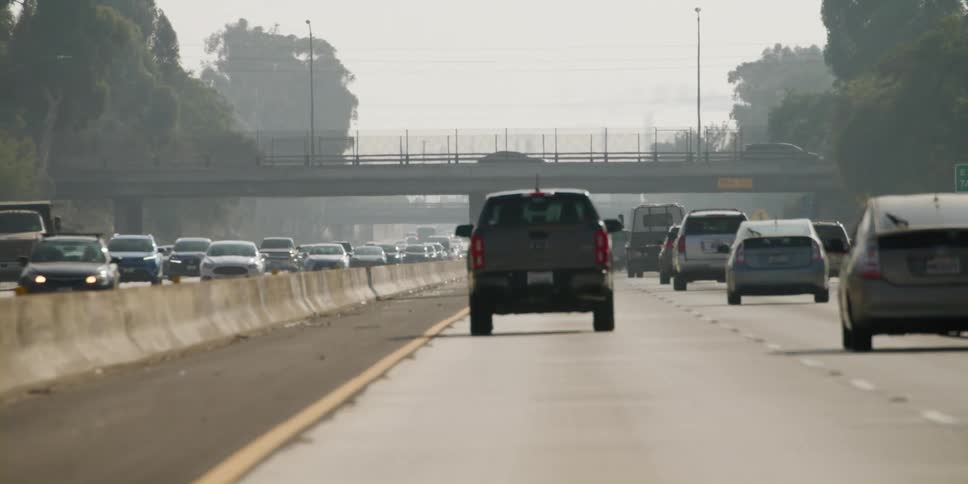 Vehicles travel along the busy freeway roads