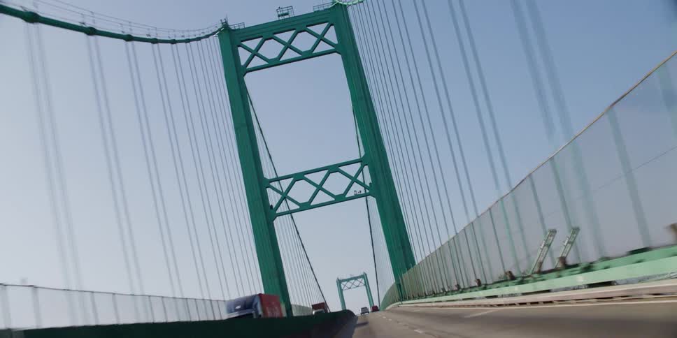 Traveling over a suspension bridge and a view up at the cables
