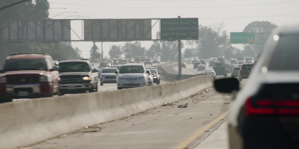 Dash cam view of vehicles commuting in traffic on freeway